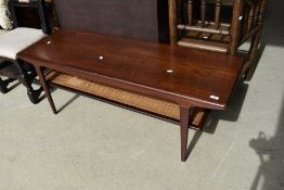 A vintage dark teak coffee table having canework undertier