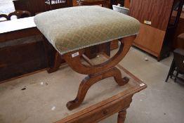 A 19th Century savanarola style stool having upholstered seat and mahogany frame