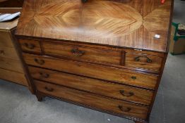 An early Victorian bureau chest of drawers having fitted interior with banded decoration and heart