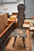 A 20th century oak spinning chair having carved back and turned legs