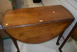 An early 20th Century mahogany drop leaf dining table having ball and claw feet