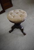 A Victorian mahogany swivel top piano stool