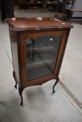 A 19th Century mahogany display or music cabinet having lined shelves and inlaid decoration