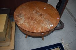 A vintage teak sewing table having butterfly style lid, quadruple splay legs