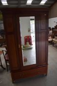 An Edwardian mahogany three piece bedroom suite comprising wardrobe, dressing table and bed rame (