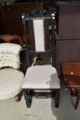 A traditional oak hall chair having later upholstery