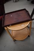 A modern light wood tea trolley and mahogany tray