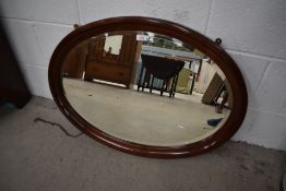An early 20th Century mahogany oval wall mirror