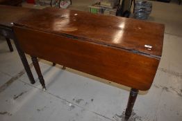 A Victorian Mahogany drop leaf dining table with turned legs