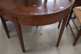 A Victorian Demi Lune fold over tea table in mahogany on fluted legs, with inlaid decoration to