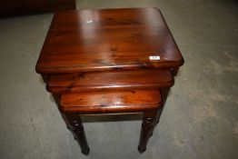 A nest of stained pine Ducal tables.
