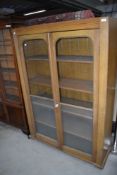 A late 19th/early 20th century vernacular utility cupboard having scumble finish and rolled glass