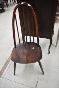A dark stained Ercol high back dining chair