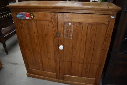 A Victorian pine side cabinet of shallow proportions, having shelved interior, width approx. 128cm