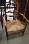 A traditional spindle back armchair having rush seat
