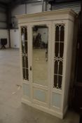 20th century shabby chic painted pine wardrobe having astral glazed doors with centre mirror