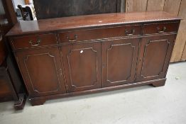 A reproduction Regency bookcase having recess to top, over four cupboard base