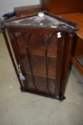 A reproduction mahogany corner wall display cabinet