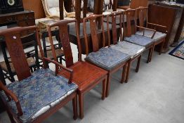 An Oriental hardwood dining table and set of six (four plus two) dining chairs