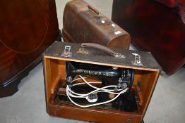 Two vintage sewing machines, in cases