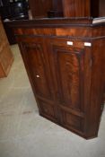 A 19th Century mahogany corner cupboard having panelled doors