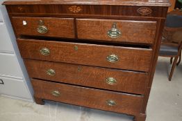 A 19th Century oak chest of two over three drawers having brass handles and bracket feet