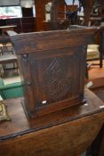 A traditional oak cabinet repurposed from clock hood