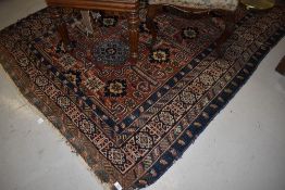 A traditional Persian style rug, worn
