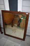 An early 20th Century oak wall mirror