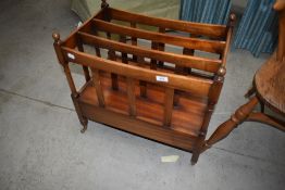 A Victorian Canterbury having mahogany frame on brass castors