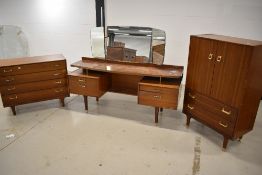 A mid century G Plan dressing table with mirror back, and two matching chest of drawers