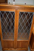 A Priory style display cabinet , in mid colour golden oak, nice condition and quality