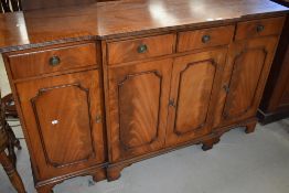 A reproduction Regency style breakfront sideboard