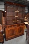 A Victorian substantial library book case and cupboard in mahogany with drawer and under cupboard