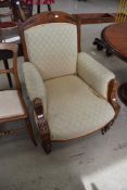A Victorian armchair having inlaid oak frame