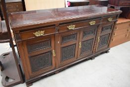 A Victorian mahogany sideboard having carved door panels, width approx. 183cm