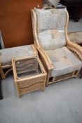 A cane work conservatory chair and footstool, and side table