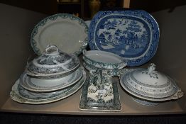 A mixed lot of antique and vintage platters, tureens and a cheese dish having transfer patterns.