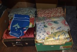 Two boxes full of good quality fabric, predominantly upholstery.