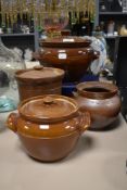 Four vintage earthen ware storage jars and tureens.