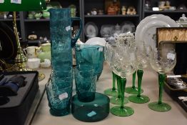 A mid century style aqua green water jug and glass set with a set of six green stem cut glass wine