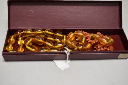 A string of polybern graduated beads of oblong form, approx 30
