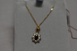A sapphire and CZ cluster pendant in 9ct gold mount on 9ct gold chain, approx 18