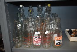 A good quantity of vintage advertising milk bottles and soda bottles, amongst which are local area
