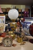 A early 20th century brass oil lamp with opaque shade, a brass blow torch, kettle, stove and