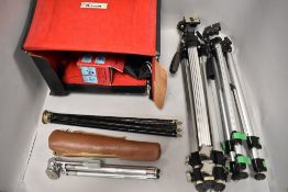 A Camera case with four tripods, connectors and filters etc