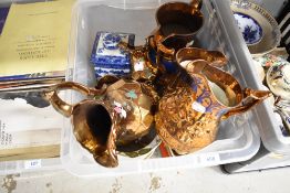 A selection of copper lustre jugs