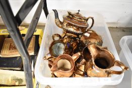 A selection of copper lustre jugs and teapot
