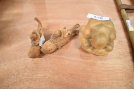 Three wooden carved figures including a pair of Chinese men with carp and a man in ball form