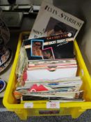A box of 70's 80's and 90's 45rpm vinyl record singles